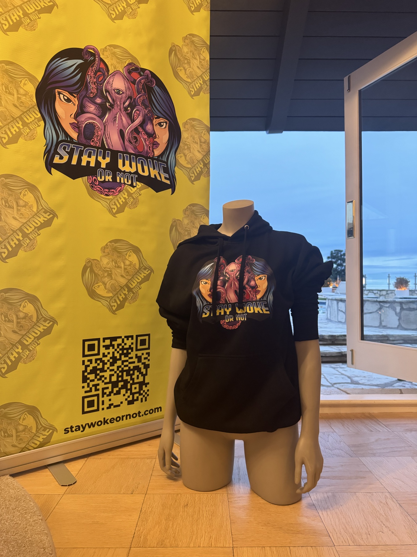 Black Stay Woke Or Not hoodie displayed at a community pop-up