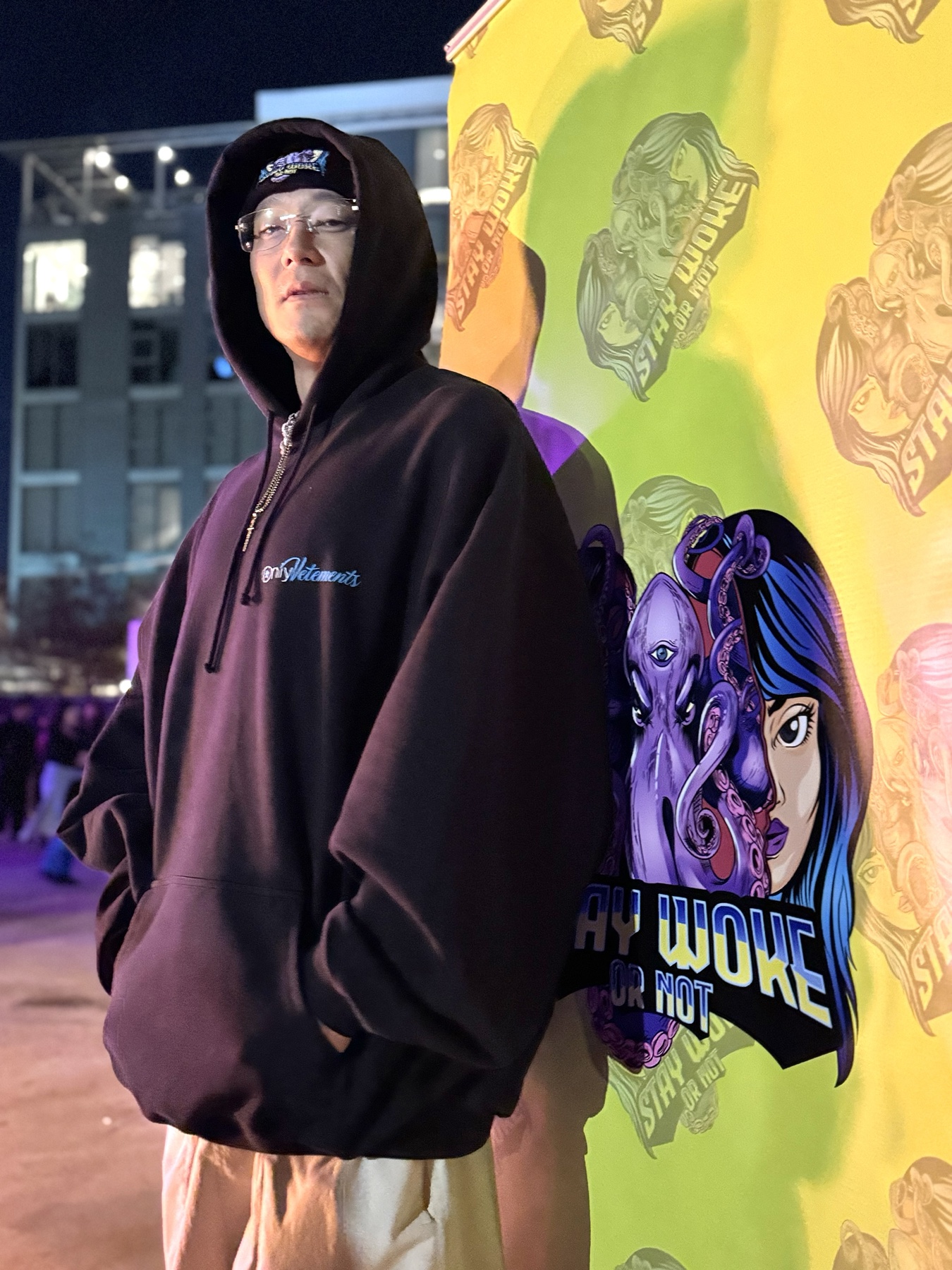 Community member wearing a Stay Woke Or Not beanie at the merch pop-up